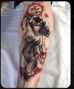 a woman's leg covered in blood and ink with a tattoo design on it