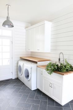 a washer and dryer in a white kitchen