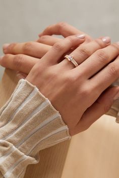 a woman's hand with a diamond ring on it