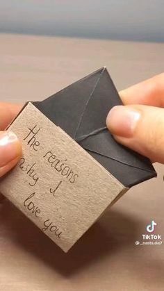 two hands holding an origami envelope