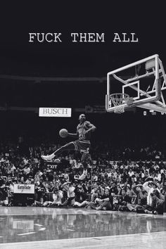 a black and white photo of a basketball player dunking the ball