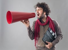 a man with a red megaphone yelling into it