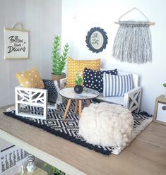 a living room filled with lots of furniture and decor on top of a wooden table