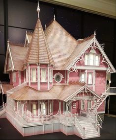 a paper model of a pink victorian house