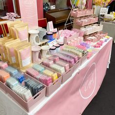 a table with many different types of soaps and lotions on display at a store