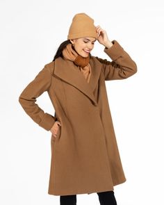 Discover the epitome of American-made elegance with this classic camel colored wool coat. This timeless knee-length coat is not only stylish but also provides exceptional warmth. Crafted with meticulous attention to detail, it features a fully lined body and sleeves, in a contrasting stripe lining.Designed for both style and functionality, this camel coat boasts a deep collar, deep on-seam side pockets, and adjustable cuffs, ensuring a perfect fit for arms of all lengths. For a secure closure, w Classic Camel Winter Outerwear, Camel Outerwear With Lapel Collar For Winter, Camel Lapel Collar Outerwear For Winter, Camel Long Sleeve Business Outerwear, Camel Business Outerwear, Camel Long Sleeve Wool Coat For Winter, Camel Wool Long Coat For Winter, Camel Wool Coat For Workwear In Fall, Camel Wool Coat With Long Sleeves For Winter