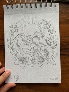 a drawing of flowers and mountains on a piece of paper