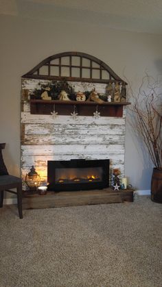 a living room with a fire place next to a wall filled with fake pumpkins