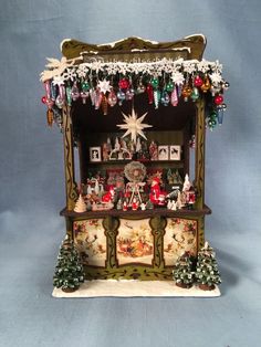 an old fashioned christmas display case with ornaments