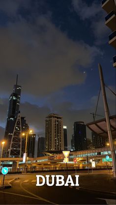 an image of a city at night with the word dubai written in front of it