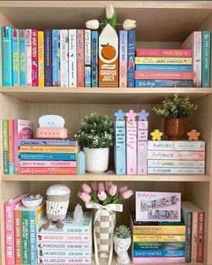 a bookshelf filled with lots of different types of books and vases on top of it