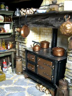 an old fashioned stove with pots and pans on it