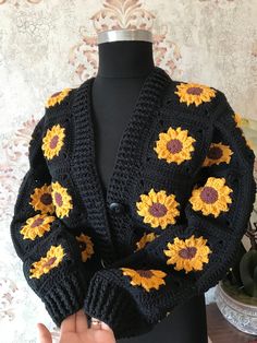 a crocheted jacket with sunflowers on it