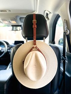 This Leather Hat Holder for cars and trucks is a simple and practical solution for keeping your hats secure while you drive. It is crafted from top-quality leather and designed to fit securely in your vehicle's headrest. Its durable construction allows for repeated use and its adjustable straps let you customize the fit. Available in brown and black genuine Italian leather. Fits up to a Size 8 / 25" circumference hat. Adjustable Hat With Curved Brim For Everyday Use, Cowboy Hat Rack, Trajes Country, Hat Holder, Chapeau Cowboy, Leather Hat, Hat Rack, Leather Hats, Cars And Trucks