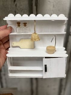 a miniature shelf with various items on it