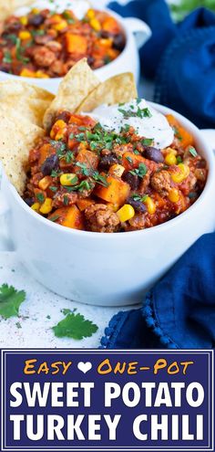 two bowls filled with sweet potato turkey chili and tortilla chips on the side