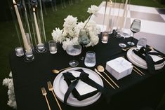 a table set with black and white place settings