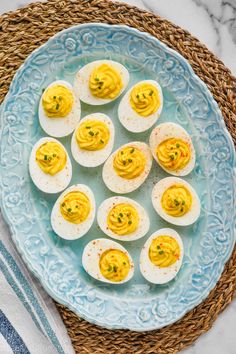 deviled eggs on a blue plate with text overlay that says secret ingredient deviled eggs