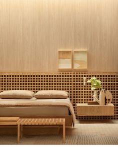 a bed sitting in a bedroom next to a wooden wall