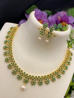 A breathtaking American Diamond necklace jewelry design from INDIAN DESIGNZ.  South Indian inspired design choker necklace in floral motif richly studded with red rubies, emerald, white, sapphire blue and white stones.   The necklace comes with matching pair of earrings with push back lock. Elegant Green Flower Shaped Jewelry, Elegant Green Flower-shaped Jewelry, Green Flower Shaped Jewelry For Wedding, Green Flower Shaped Wedding Jewelry, Green Flower-shaped Wedding Jewelry, Fine Jewelry In Flower Shape And Green Color, Fine Jewelry In Green With Flower Shape, Fine Jewelry With Green Flower-shaped Gemstones, Fine Green Jewelry In Flower Shape