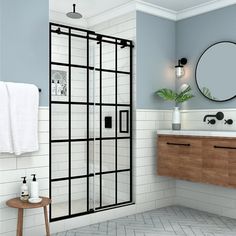 a bathroom with blue walls and white tile flooring, a wooden cabinet under the mirror