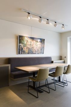 a long table with four chairs in front of it