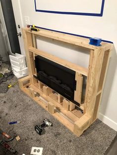 an unfinished entertainment center is being built in the living room