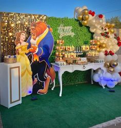 a table with balloons and decorations for a beauty and the beast birthday party on it