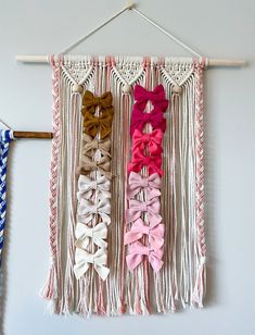 the wall hangings are decorated with different colors of hair bows and tassels