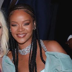 two women with braids posing for the camera