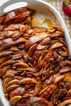 a casserole dish filled with meat and apples