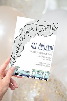 a person holding up a card that says, it's an adorable little train