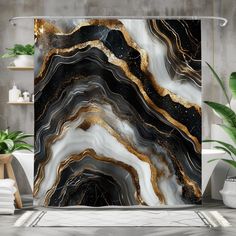 a black and white shower curtain with gold foiling on the edges, in a bathroom