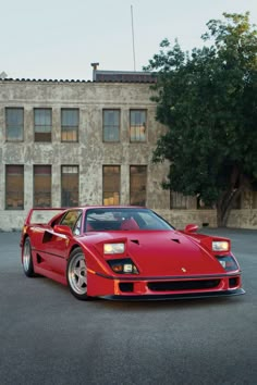 a red sports car parked in front of a building