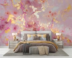 a bedroom with pink and gold paint on the wall, bedding and nightstands