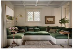 a living room with green couches and rugs