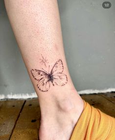 a small butterfly tattoo on the left ankle, with dots in it's wings