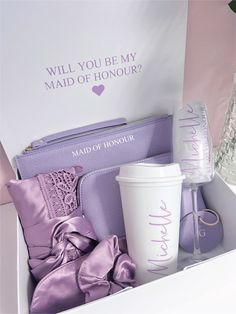 the contents of a woman's personal care kit in a white box with purple satin