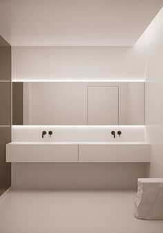 a bathroom with two sinks and mirrors on the wall next to each other in black and white