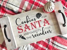 a wooden sign that says cookies for santa and carrots for the reindeer