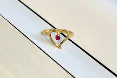 A Vintage 14k Gold Heart Ring Set with Ruby All items are XRay and Acid tested to ensure metal authenticity.  Weight: 3.2 grams Ring Size: 5.5 (resizing available upon request) 14k Gold Heart-shaped Solitaire Ring, Classic Heart-shaped Ruby Ring For Formal Occasions, Heart-shaped 14k Gold Ruby Promise Ring, Classic 14k Gold Heart-shaped Birthstone Ring, Classic Heart Ring With Diamond Cut For Valentine's Day, Classic Heart-shaped Ruby Ring, 14k Gold Ruby Ring For Valentine's Anniversary, Formal Rings With Birthstone For Valentine's Day, Formal Birthstone Rings For Valentine's Day