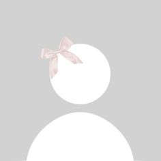 a white circle with a pink bow on the front and back of it, against a gray background