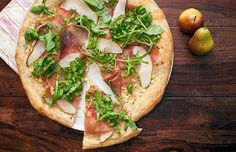 three pizzas with different toppings sitting on a table