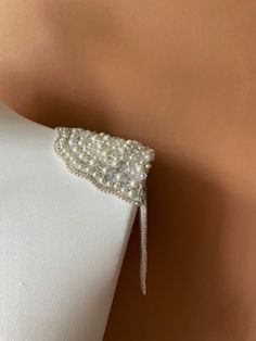 These gorgeous pearl epaulettes are unique and one of a kind piece of shoulder jewelry to go with your wedding dress, party dress or to add a touch of elegance to any formal outfit, letting you sparkle on your special event. Handmade of real pearls and sparkling rhinestones, these shoulder epaulettes will adore your outfit and make you feel like a red carpet celebrity. If you are looking a perfect finishing to your wedding dress, these epaulettes will make your bridal look gorgeous.   No matter Wedding Epaulettes, Elegant Embellished Bridal Accessories For Ceremony, Formal Embellished Pearl Jewelry, Formal Pearl Embellished Jewelry, Beaded Pearl Backdrop Necklace For Evening, White Backdrop Necklace For Evening, Elegant Pearl Embroidery Jewelry For Wedding, Evening Embellished Pearl Jewelry, Elegant Pearl Embroidery Wedding Jewelry