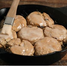 a skillet filled with meat covered in gravy