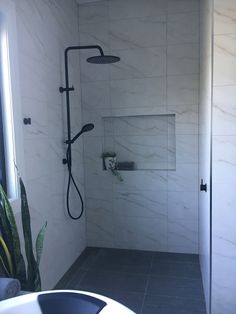 the shower is clean and ready for us to use in the bathroom or on the other side of the room