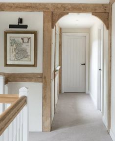 the interior of a home with white walls and wood trimming on the door frame