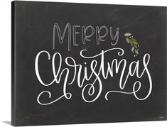 a blackboard with the words merry christmas written in white ink on it and an ornament