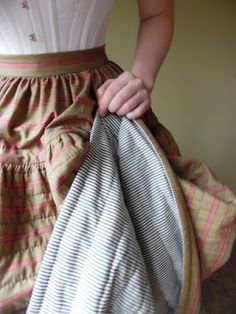 a woman is holding her skirt open and ready to wear