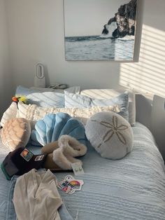 a bed with pillows and other items on it